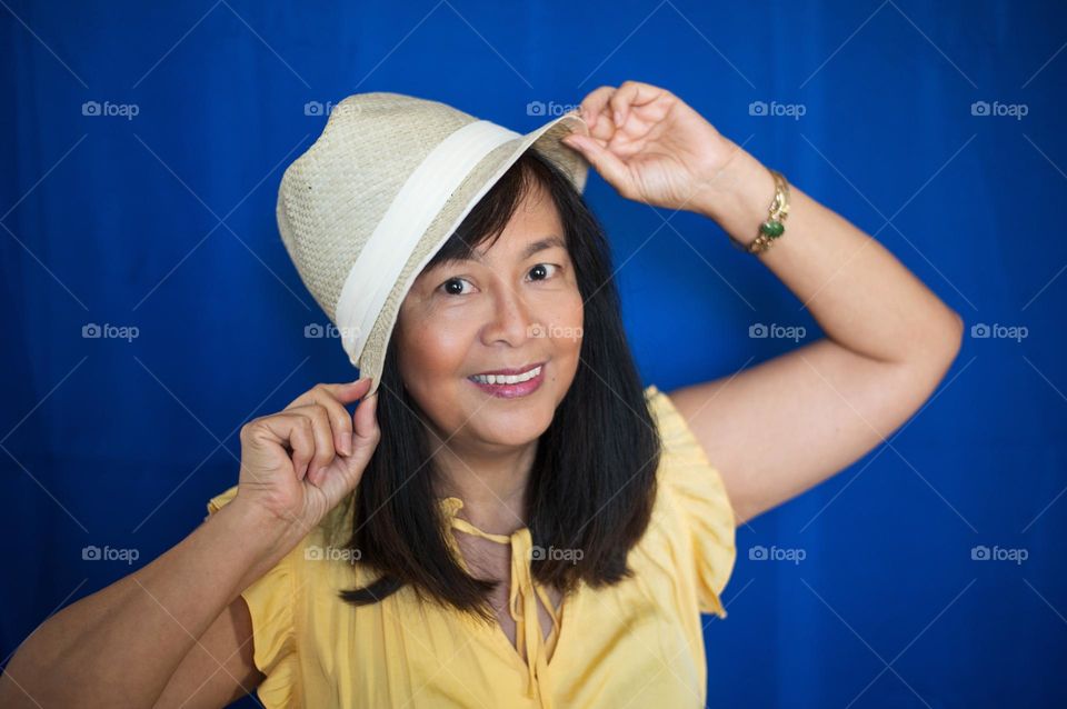 Portrait of a woman having fun with her hat