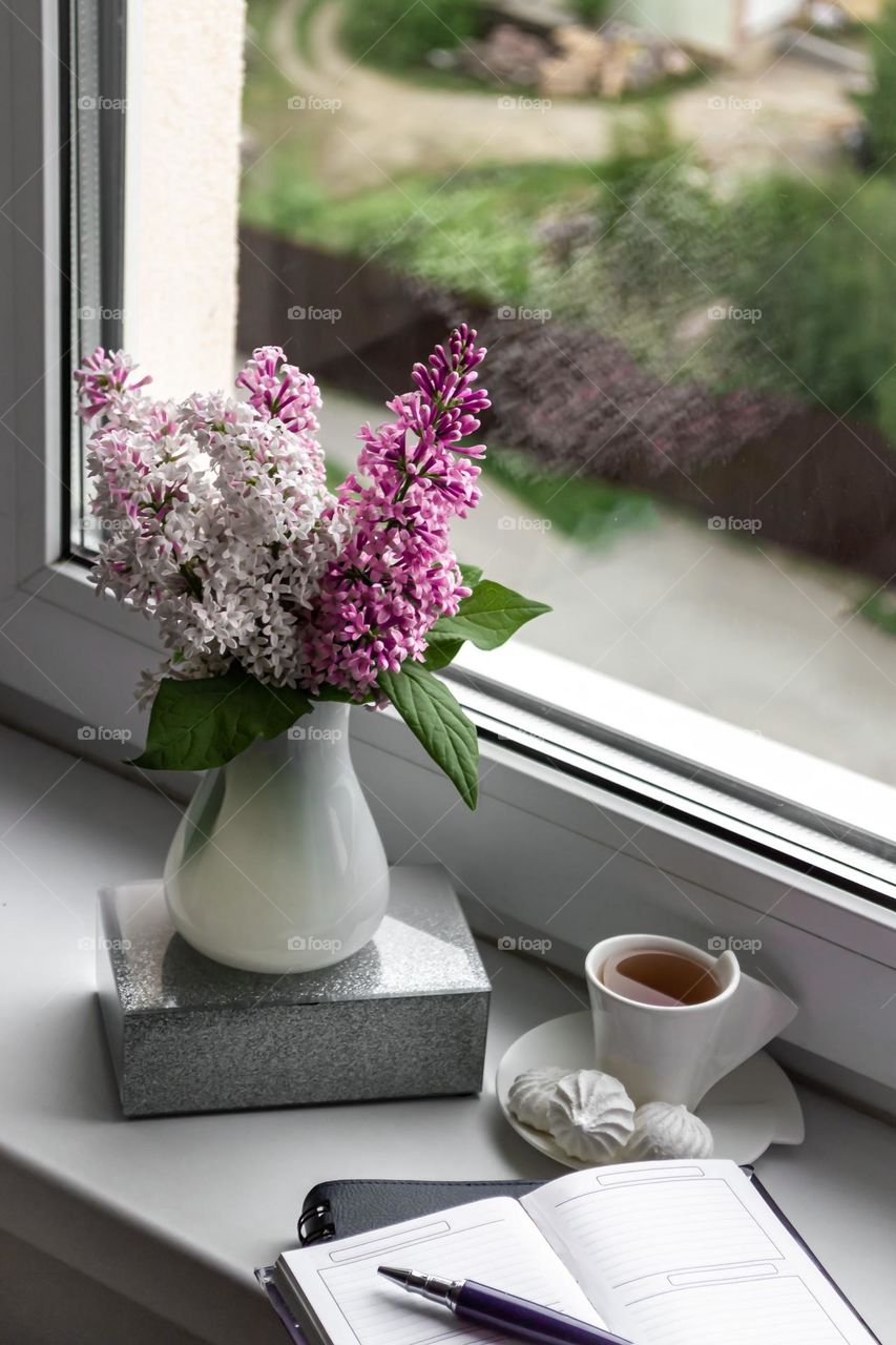 Still life flowers and coffee on the windowsill 