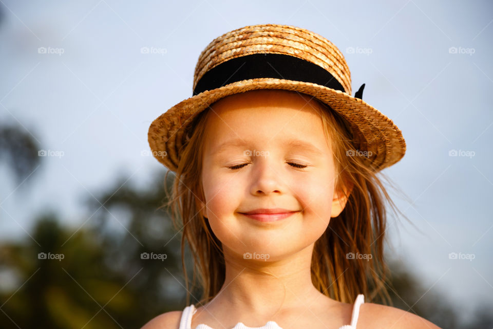 Portrait of cute little girl with blonde hair outdoor 