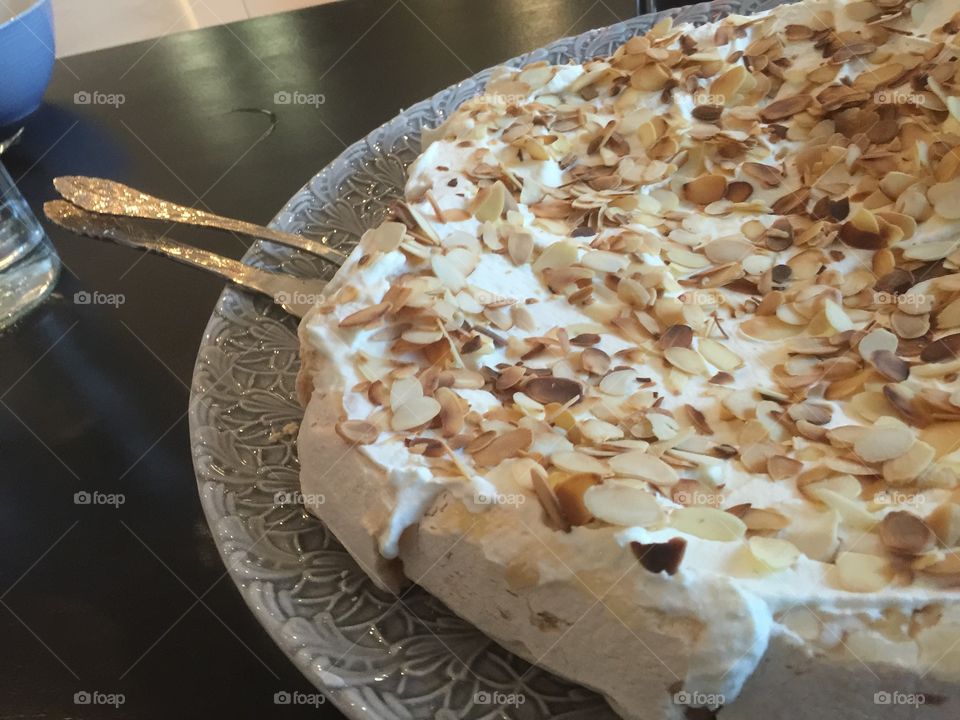 Cake with almonds and whipped cream