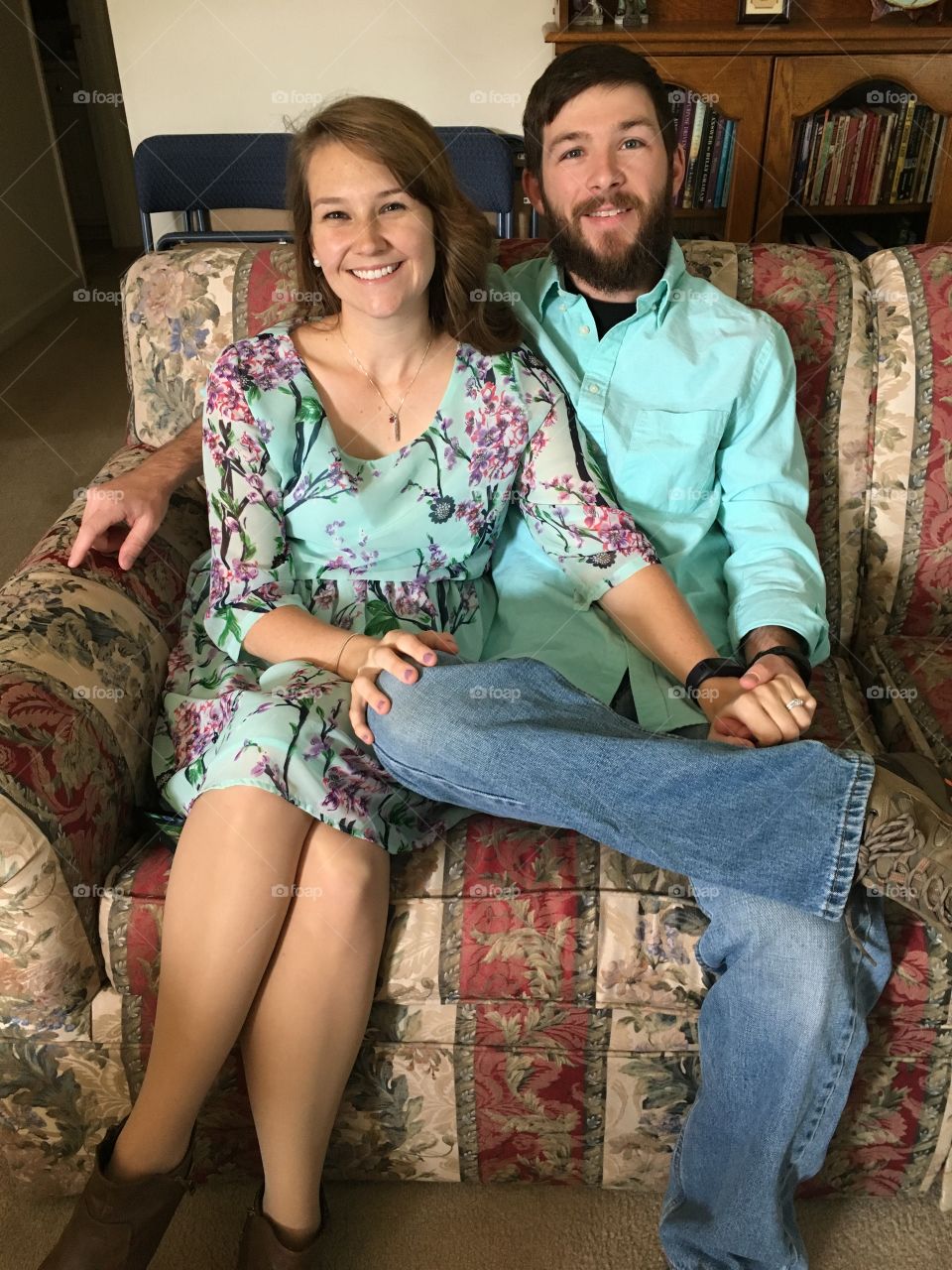 Portrait of happy couple sitting on sofa