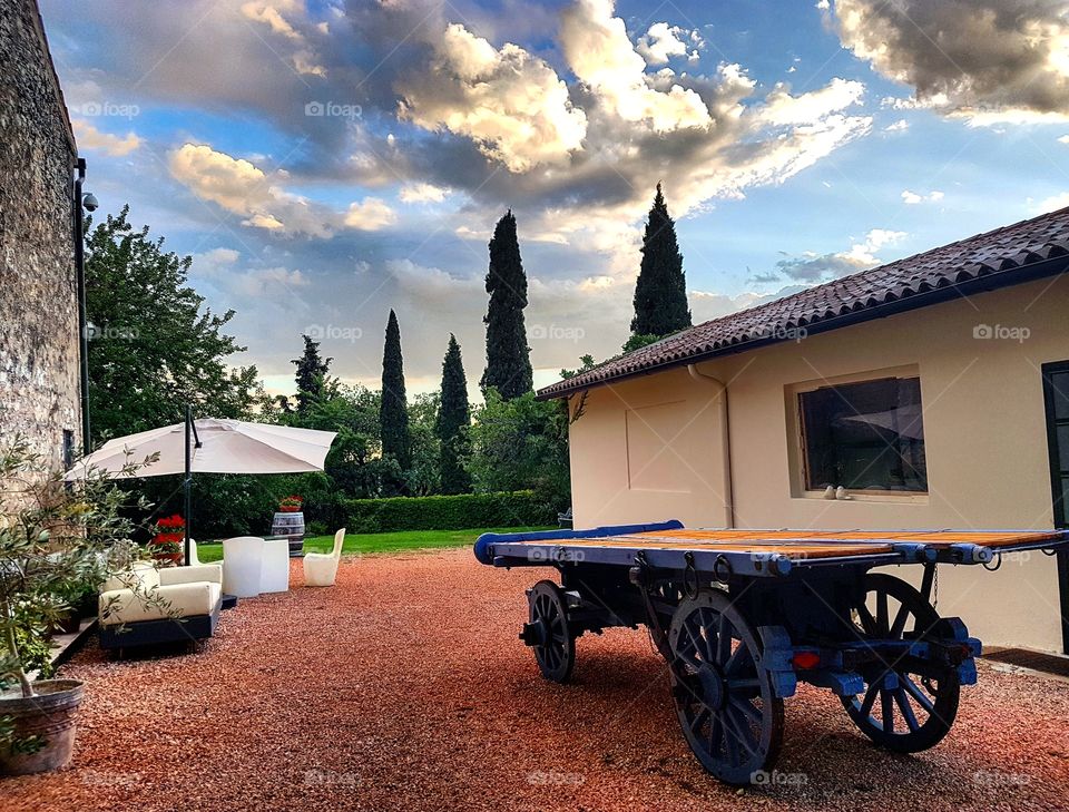 Wine Relais in Valpolicella region near Verona (Italy). A quiet shelter for tourists and wine lovers. 
This pic was taken in september when you still can enjoy long sunny days with fresh evenings.
Low clouds made this spot perfect for a shot. 
No filters were applied to this picture.
