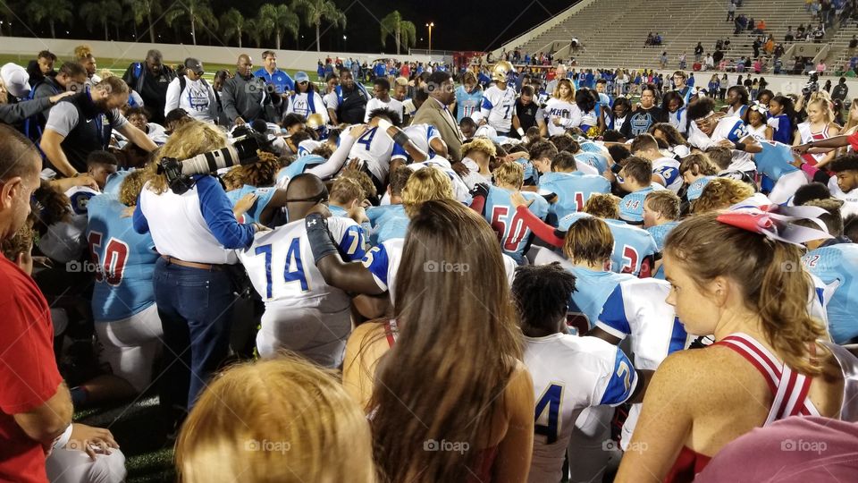 After game, teams huddles for post-game prayer