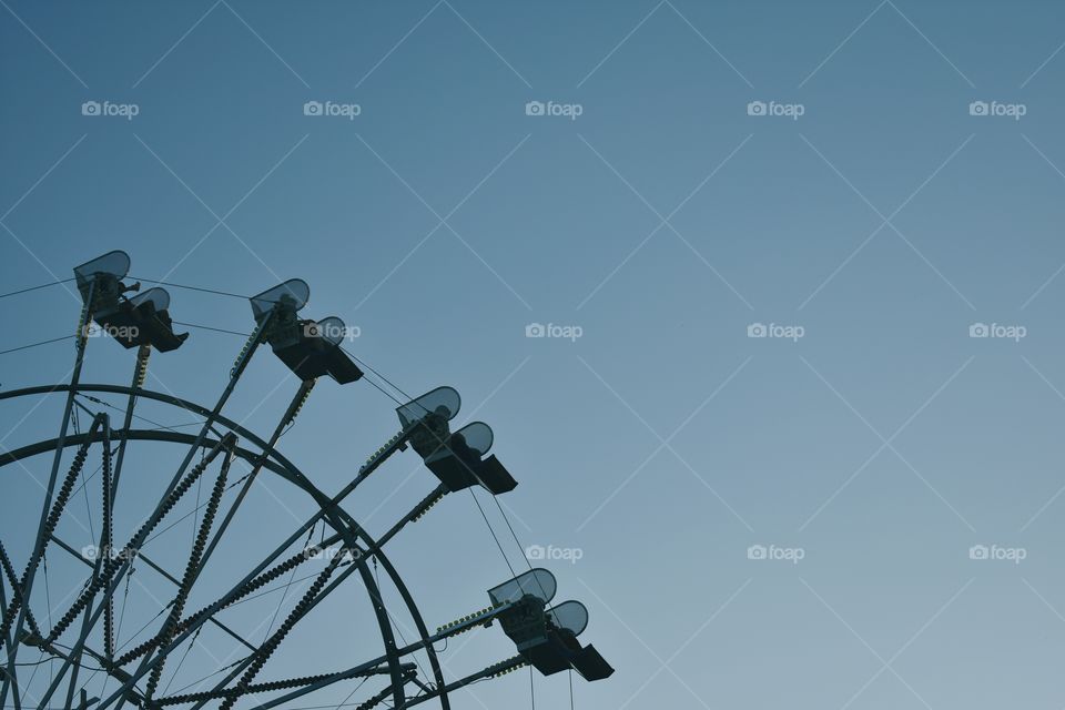 Ferris wheel against clear blue summer sky 