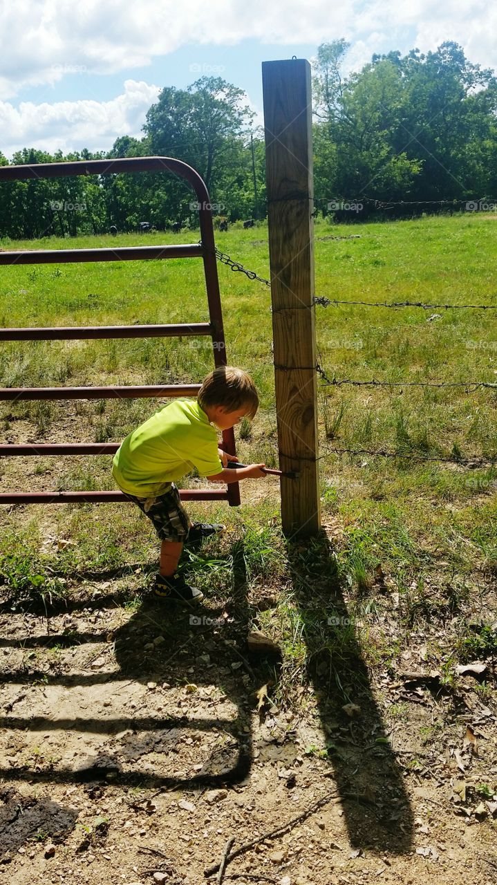 Boy fixing fence