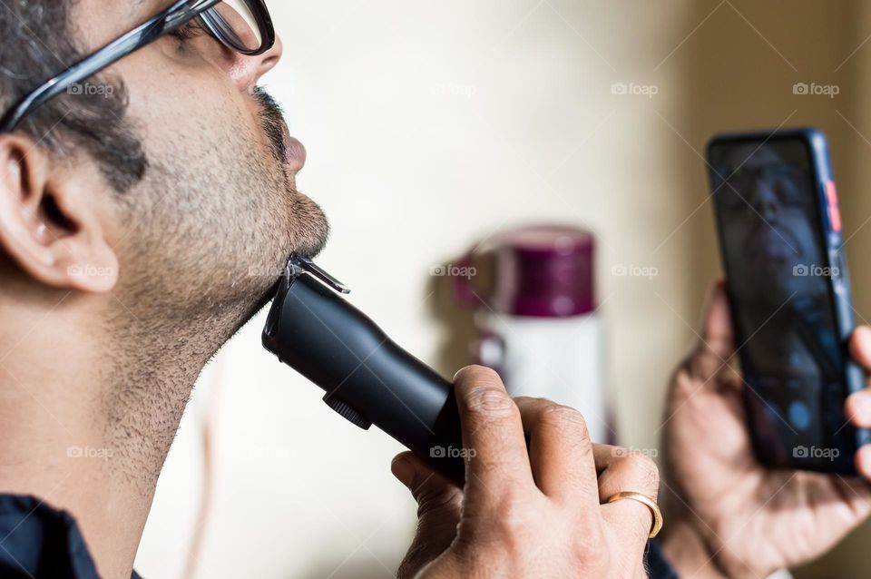 Man shaving beard.