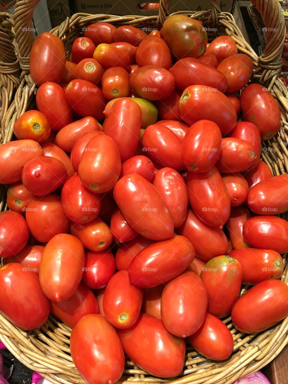 Basket load of fresh tomatoes. Plenty of ripened plum tomatoes in a large basket.🍅