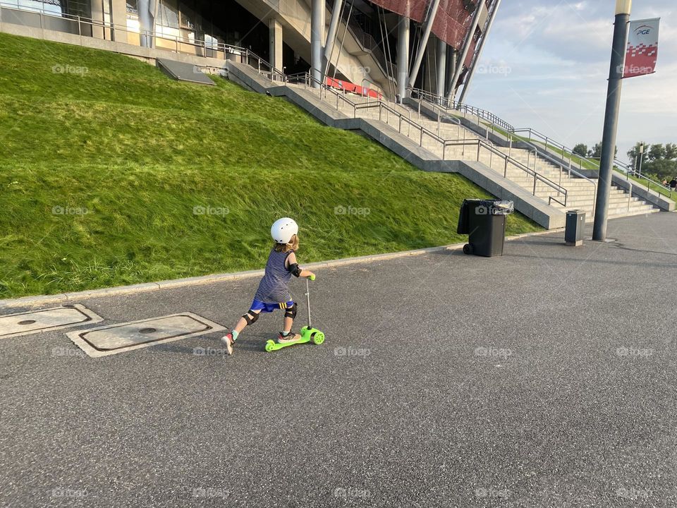 Boy riding on a scooter 