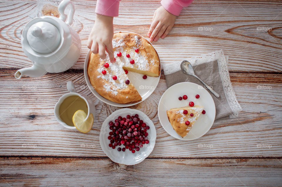 Children breakfast with cheesecake. Hands, detail