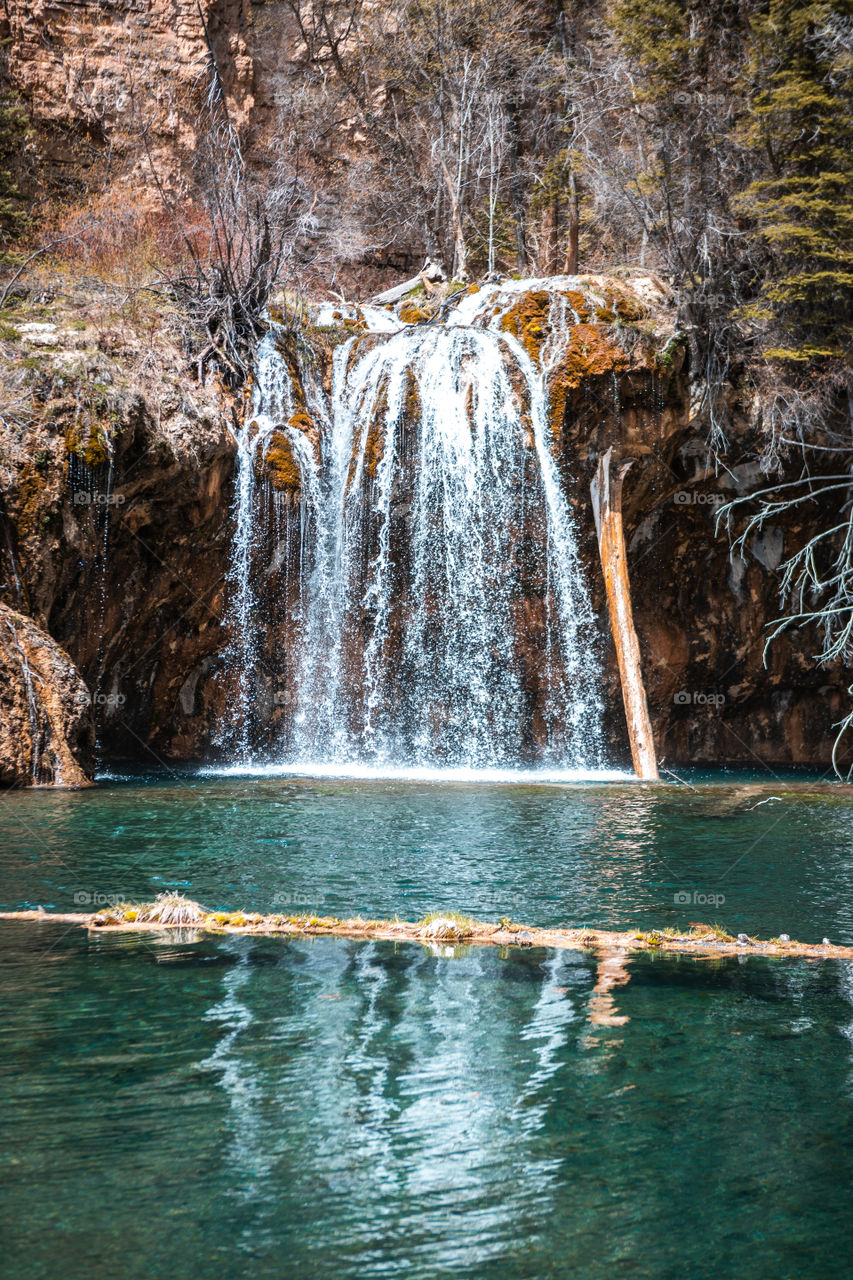 Beautiful crystal clear water flowing from a waterfall into a Colorado lake high in the mountains. 