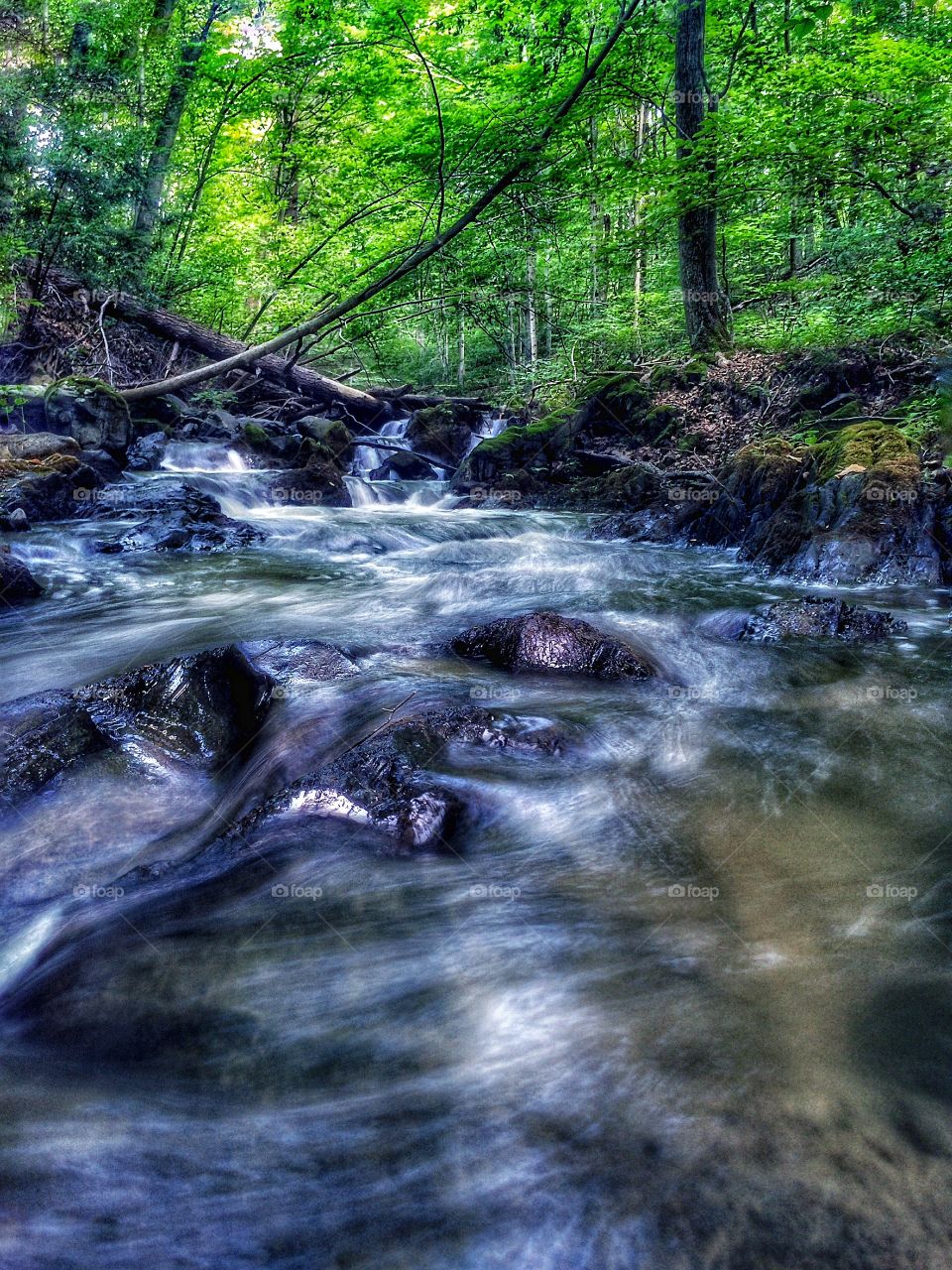 A small waterfall . A long exposure shot of a small waterfall 