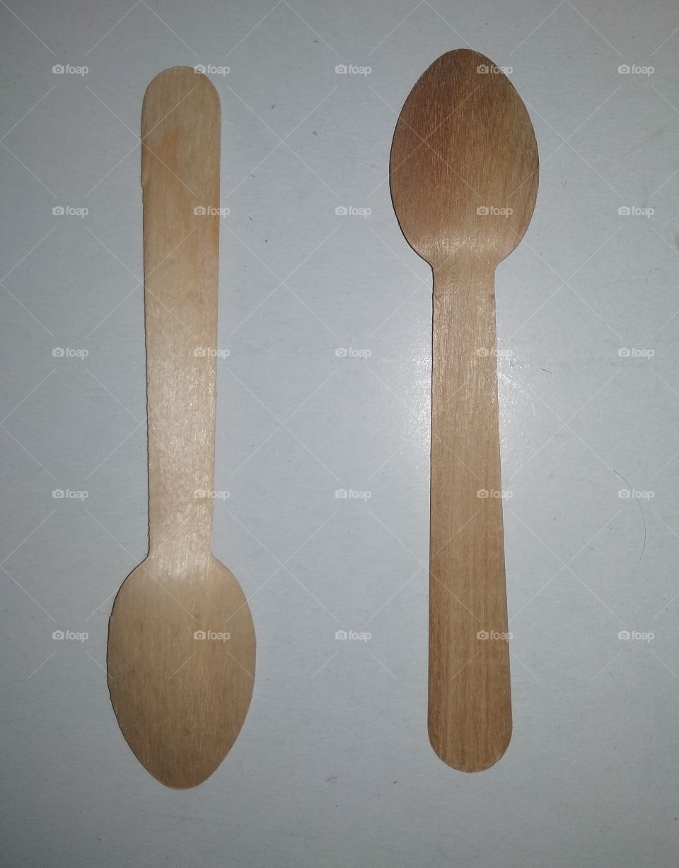 It is a wooden spoon gray background white background wood material background close up