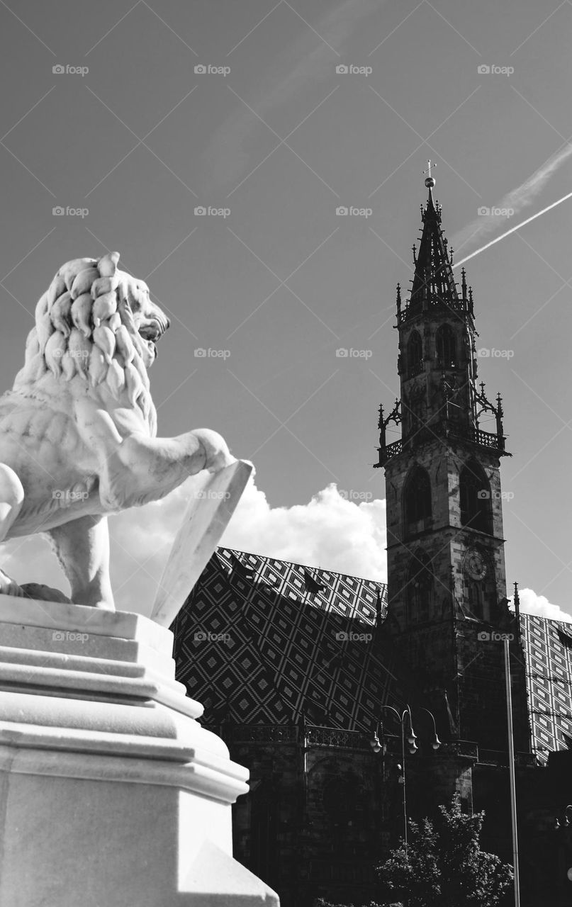 Lion sculpture and a church spire