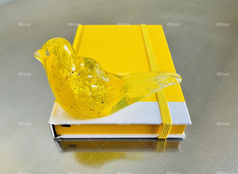 Glass bird figurine and notebook in Autumn golden color. 