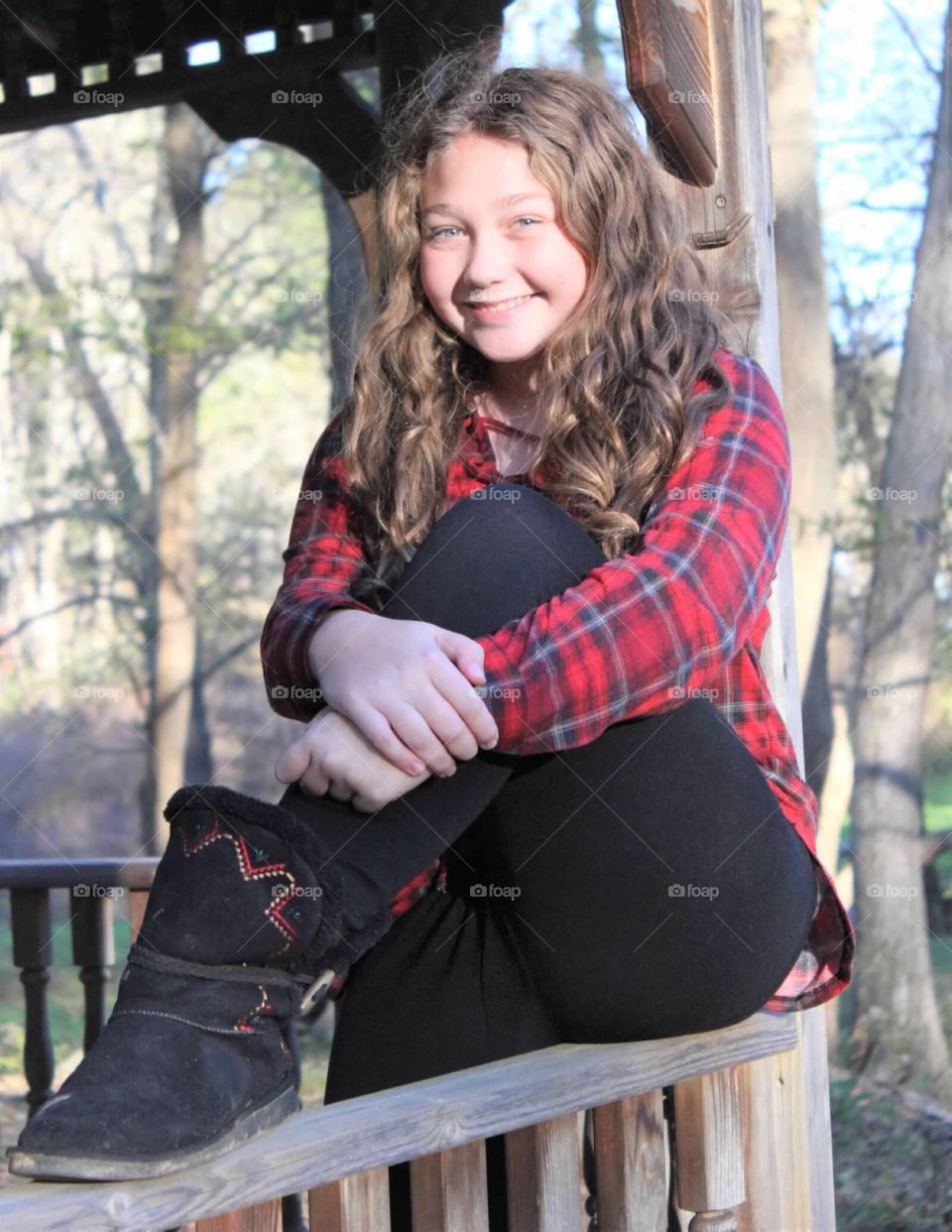 Young beautiful preteen, with a gorgeous radiating smile, posing for fall photos. 