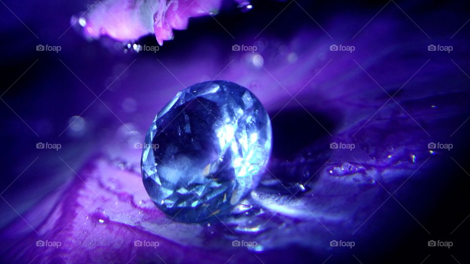 Blue Topaz with water drop on leaf