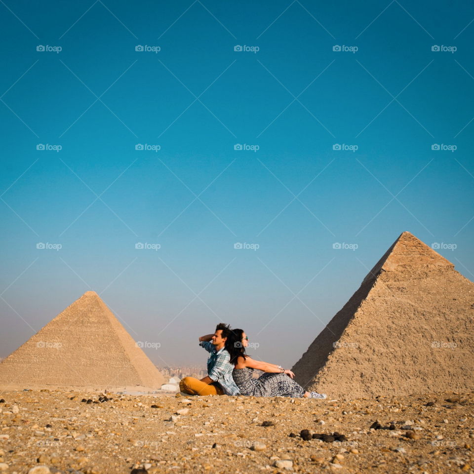 young couple travels in Egypt, view of the pyramids and the sky