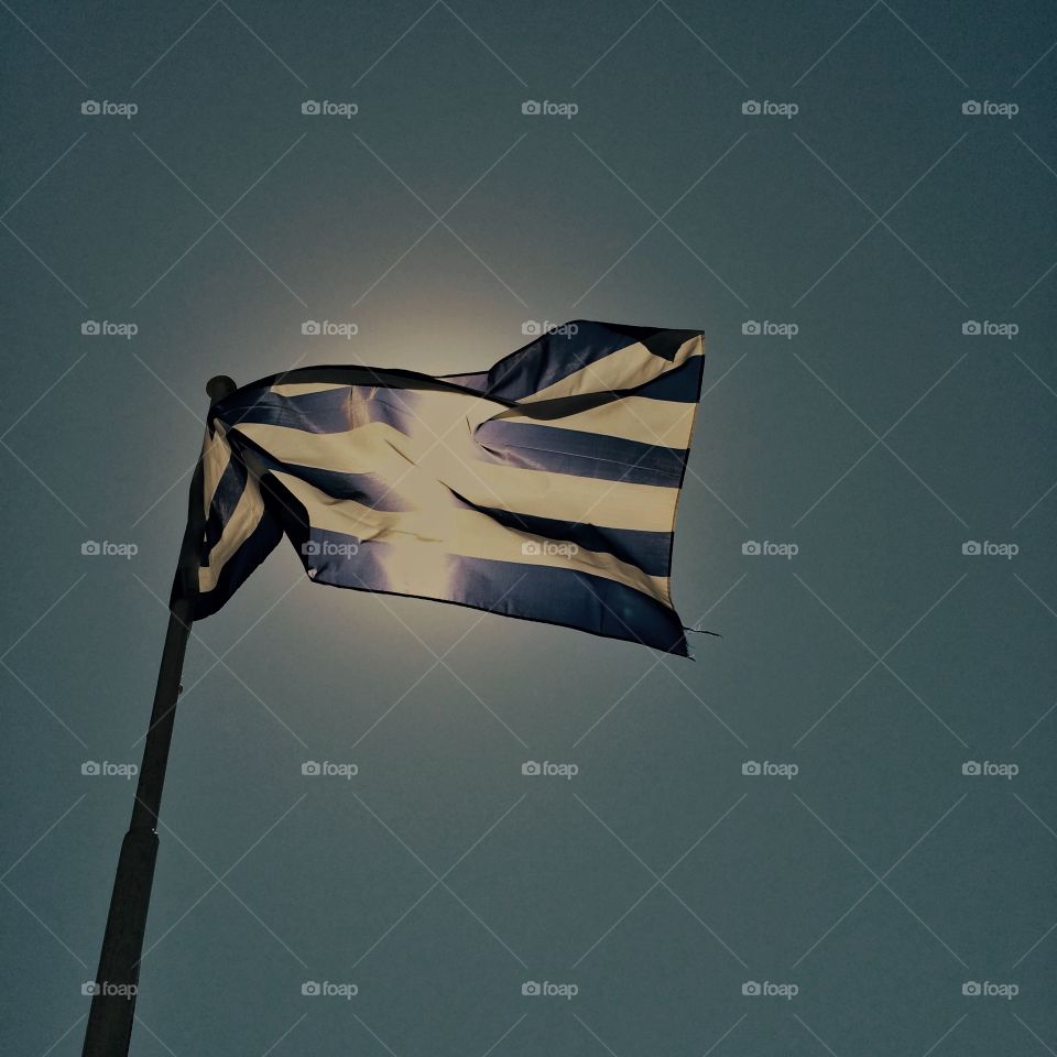 Greek flag . Greek flag shown in front of the sun
