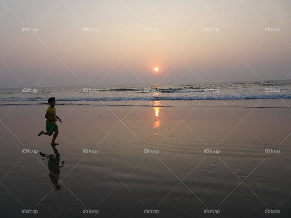 watching my son playing on the beach