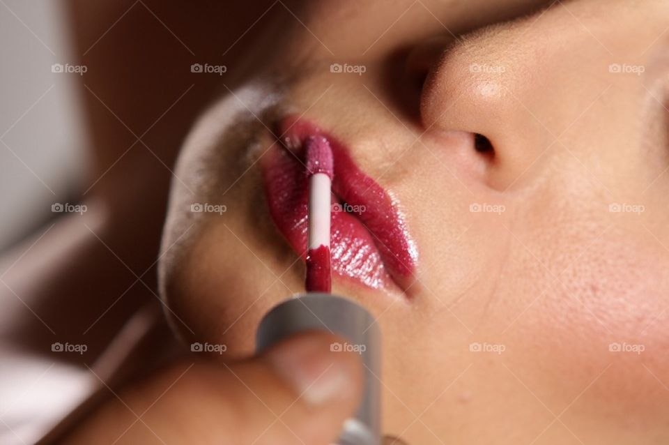 Young beautiful woman with lipstick