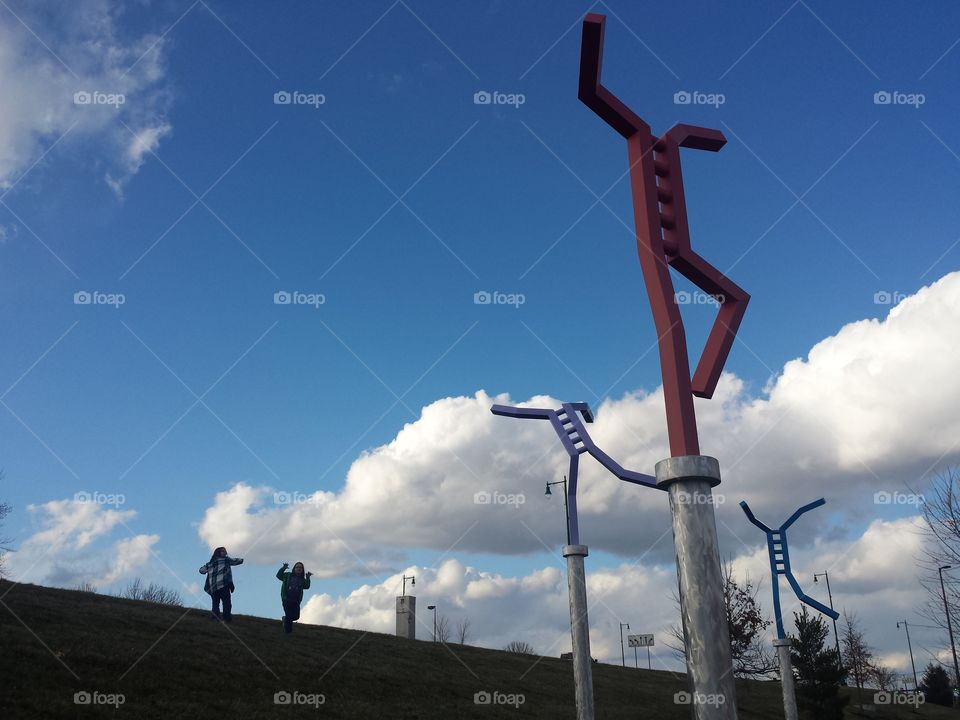 Metallic sculpture on pole