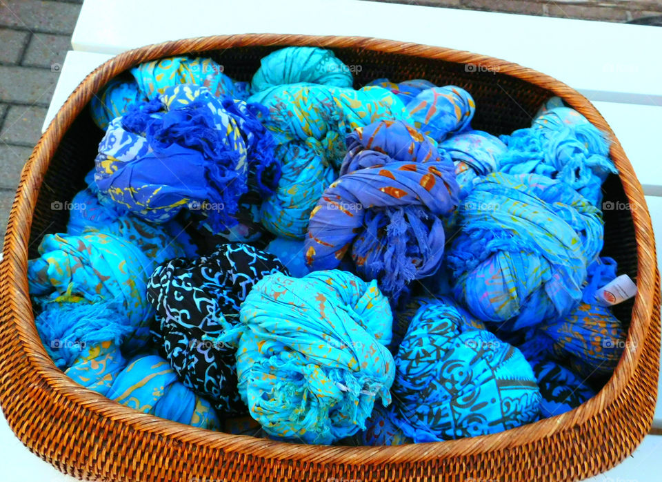 Blue scarfs on wicker basket