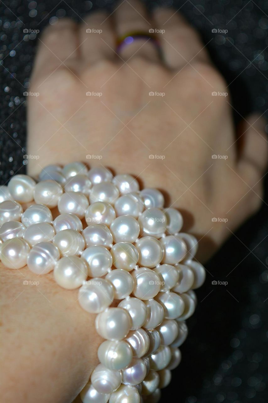 female hand with bracelet pearls beautiful accessories close up