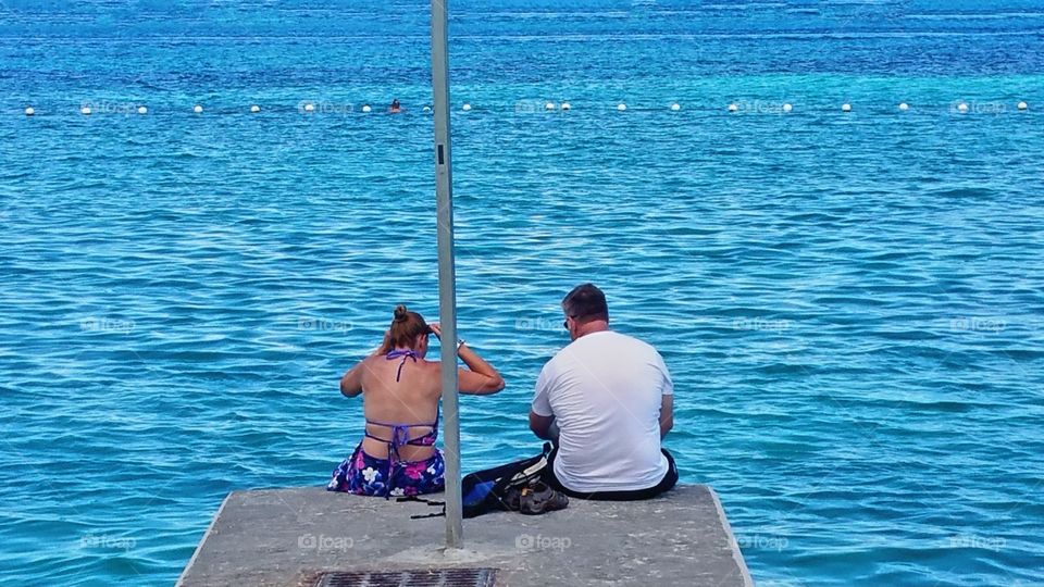 Couple at end of dock Nassau Bahamas