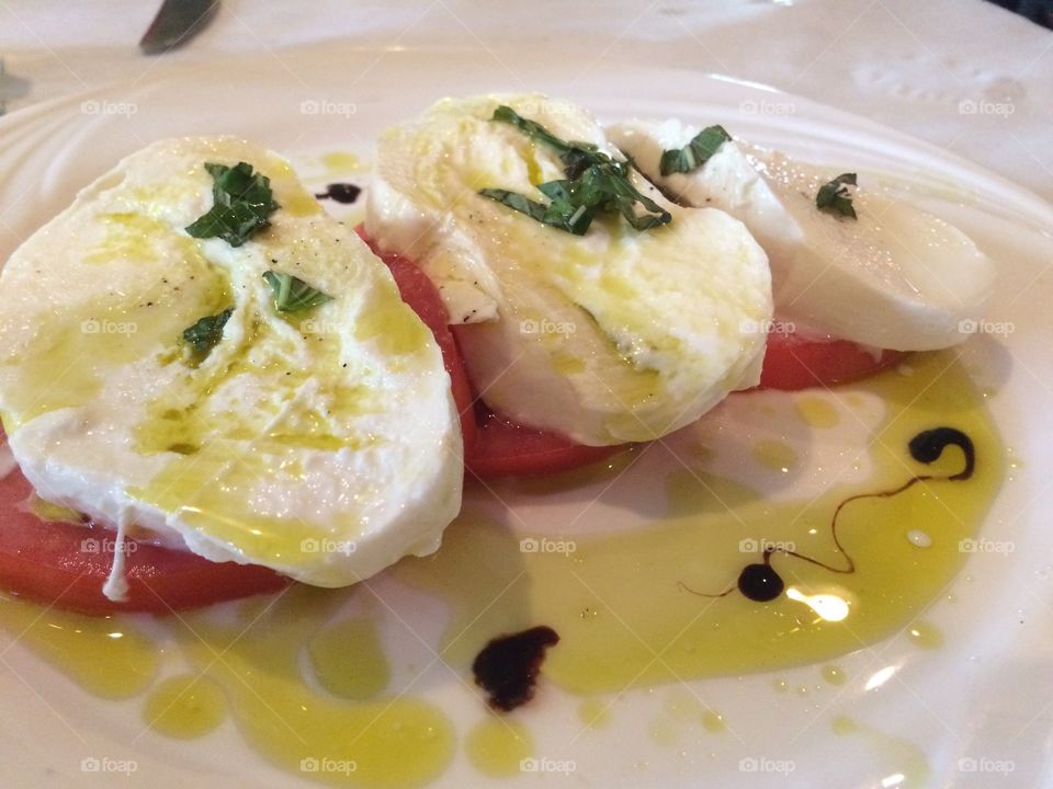 Insalata Caprese. Caprese salad - fresh tomatoes topped with mozzarella & olive oil. Photo by Tony Azzaro.