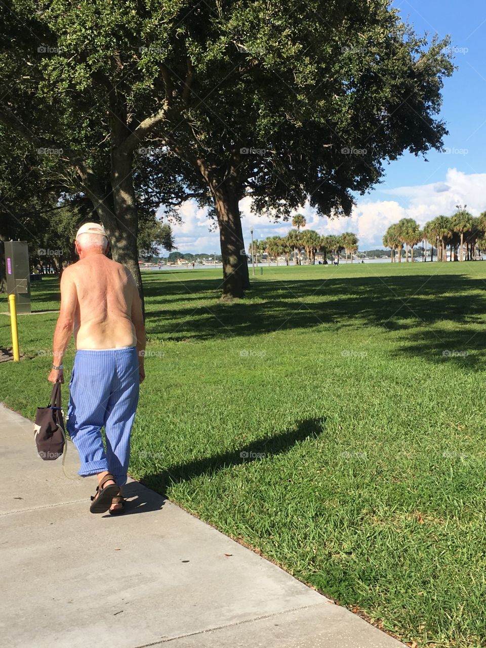 Topless grandpa with pj bottoms taking a walk