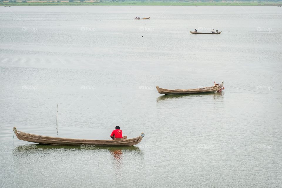 Local life style of fisherman in Early morning at Uben bridge , the longest wooden bridge in the world.