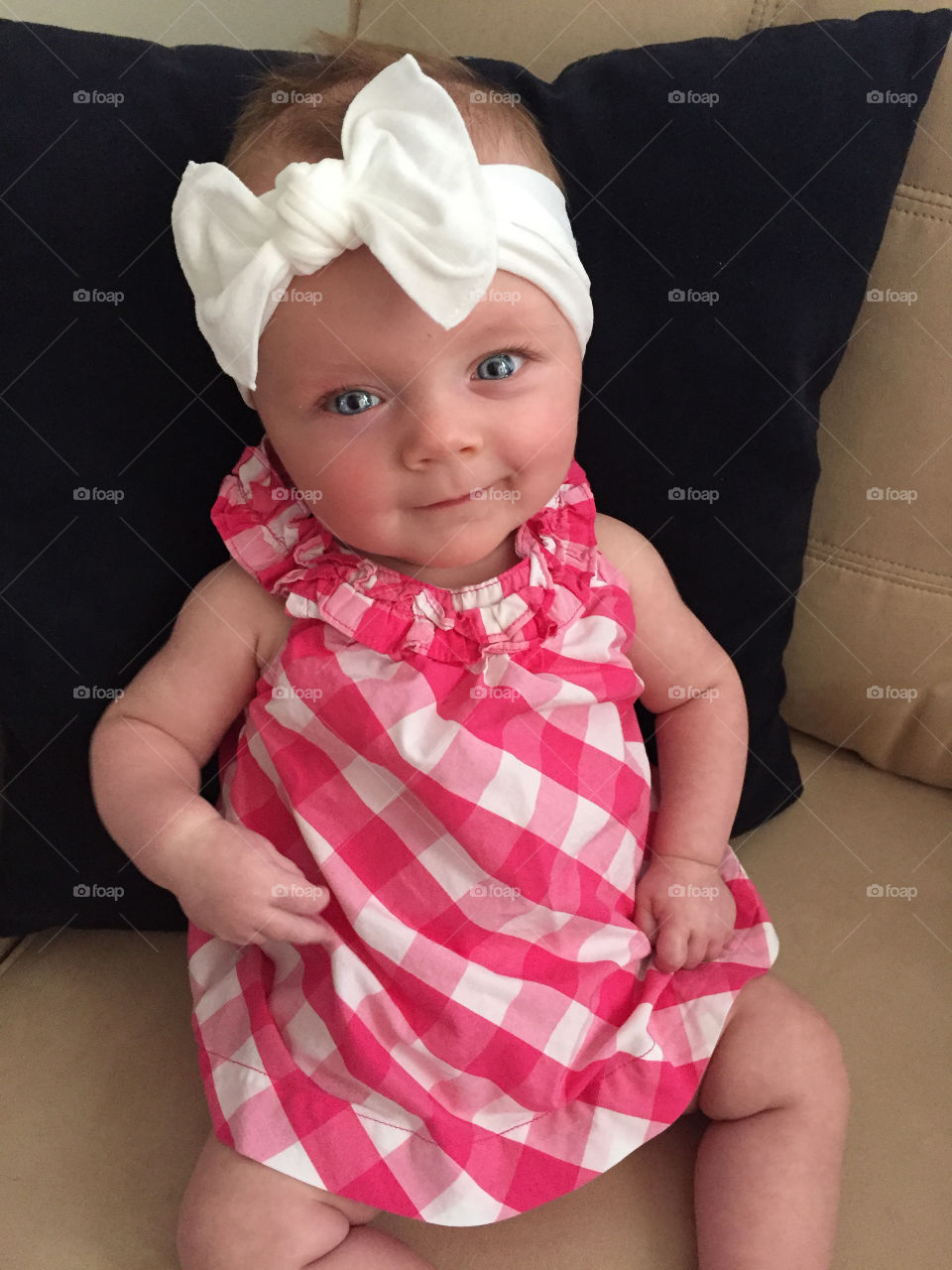 Smiling cute baby girl with white headband