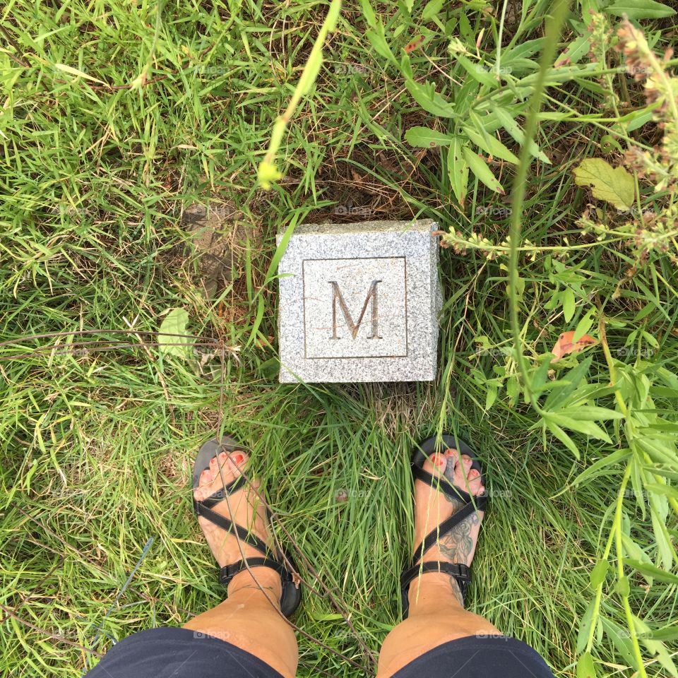 At a cemetery, I was walking in an older area, and from where I stood there was a marble corner marker with my initial on it. What are the chances! FREAKY!