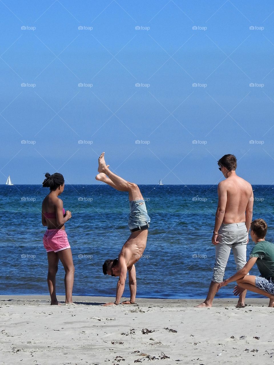 Hand stand on the beach