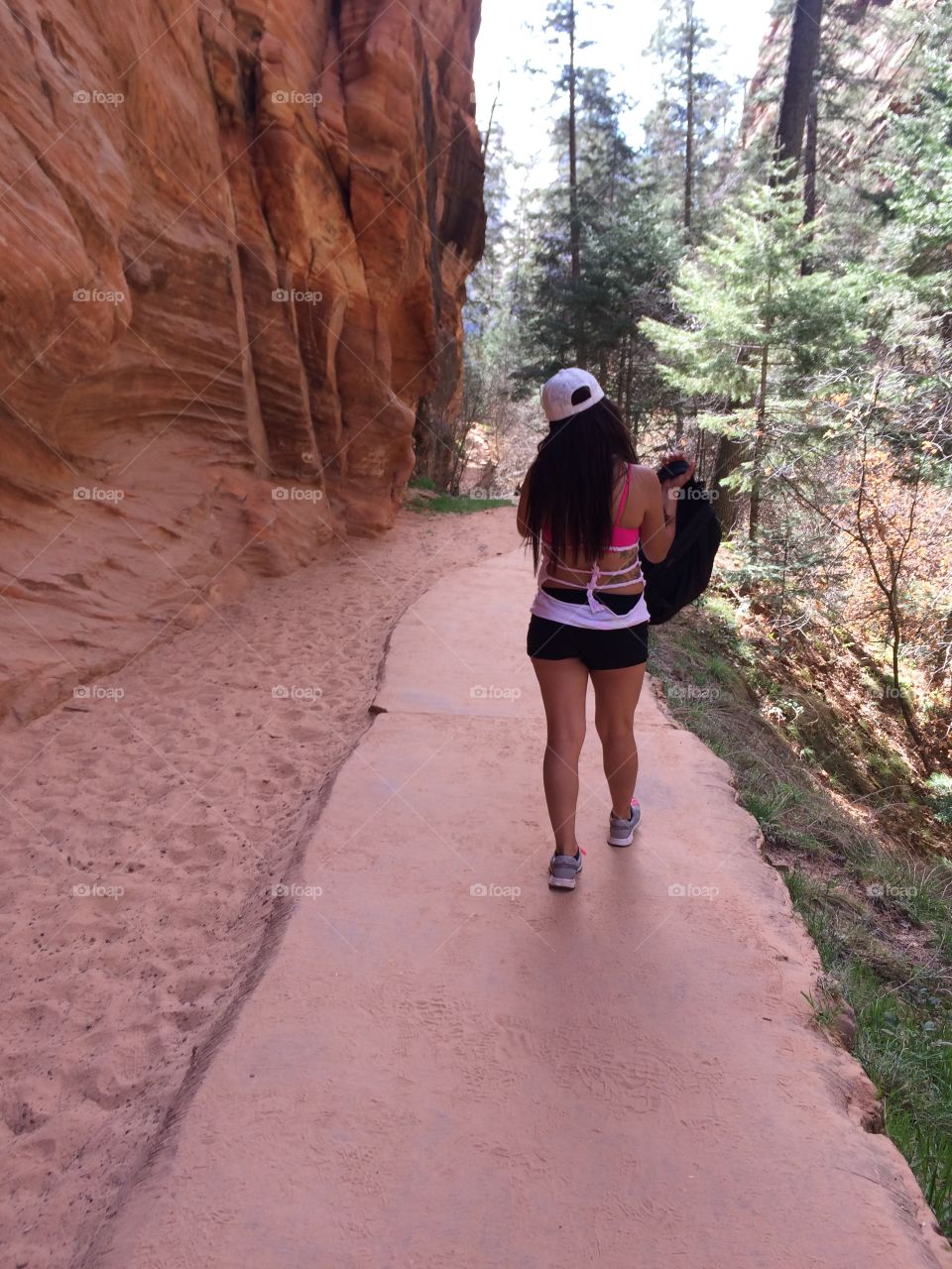 Hiking. Girl with white hate walking at Zion 