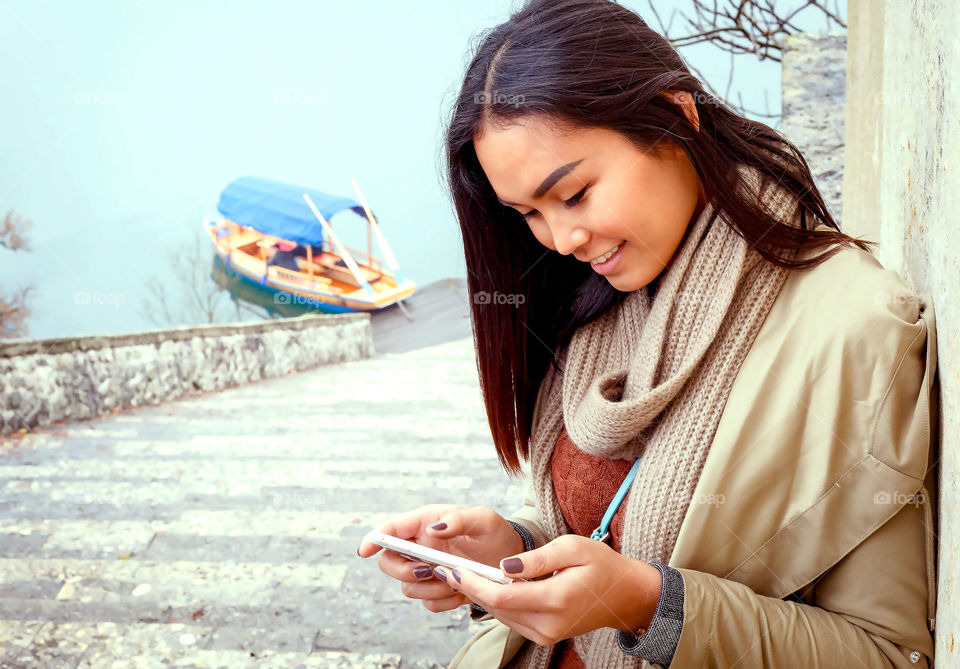 Happy beautiful woman using Smartphone