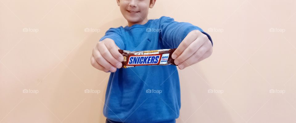 boy holding snickers