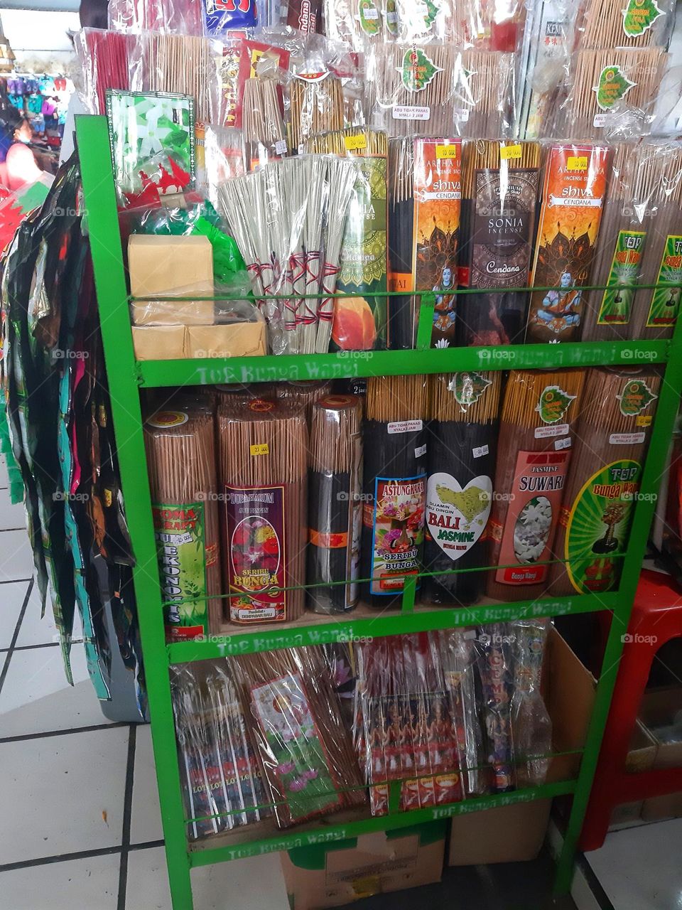 The balinese lightsticks that needed for evwry cetemony are displayed on the green plastic rack