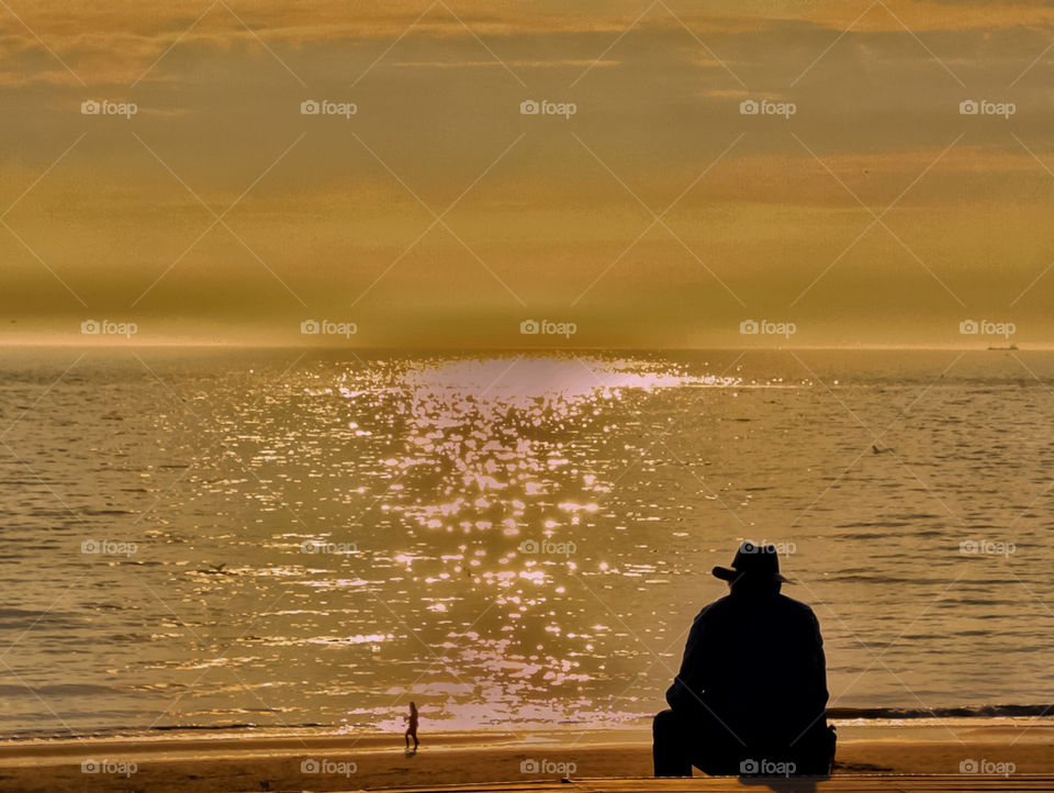 Old man watching the sun set