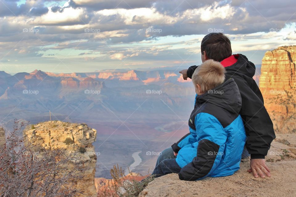 pointing to the grand canyon