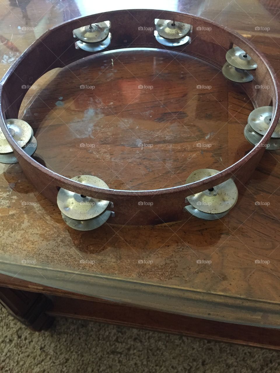 Tambourine on glass table. 