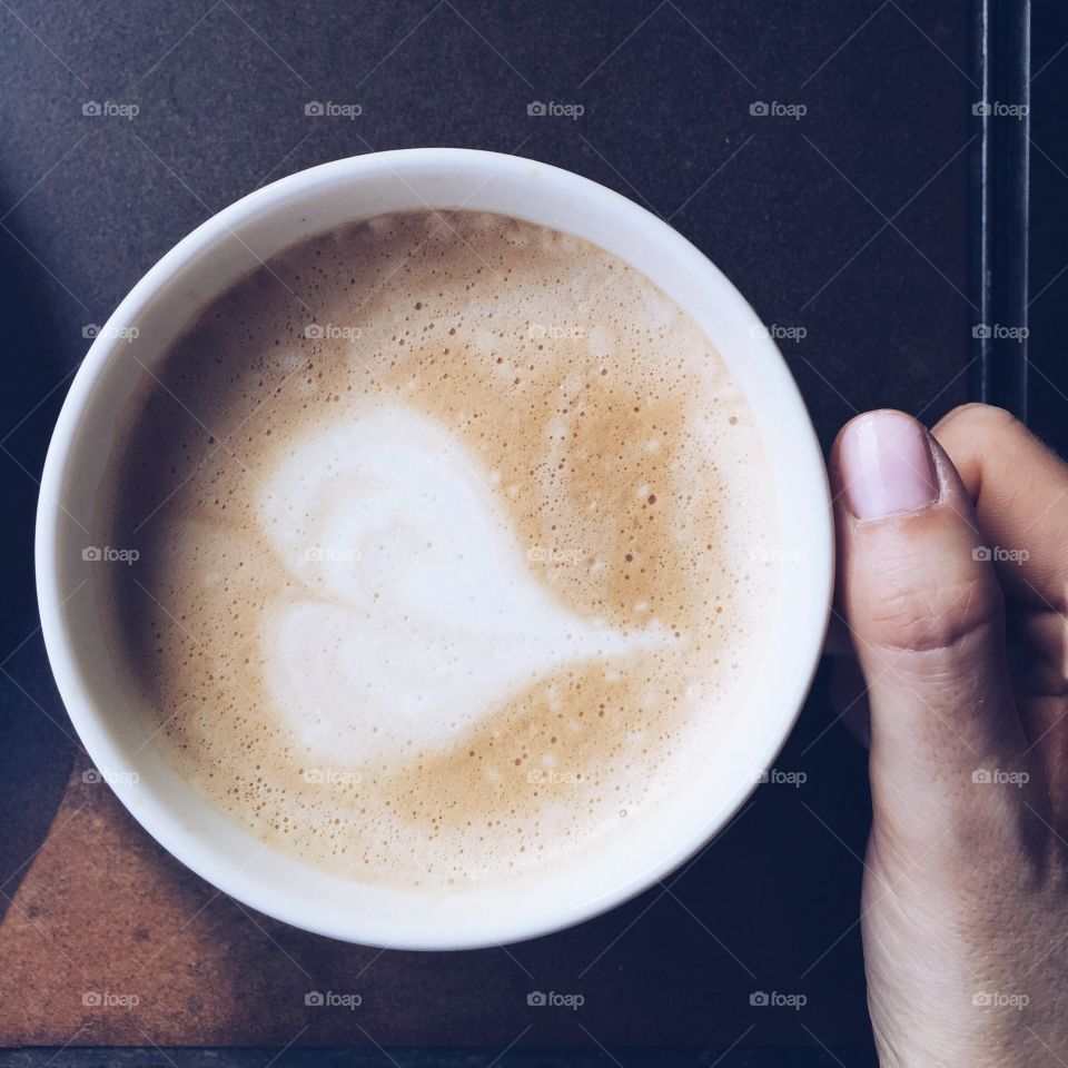 Close-up of person's hand with hot coffee