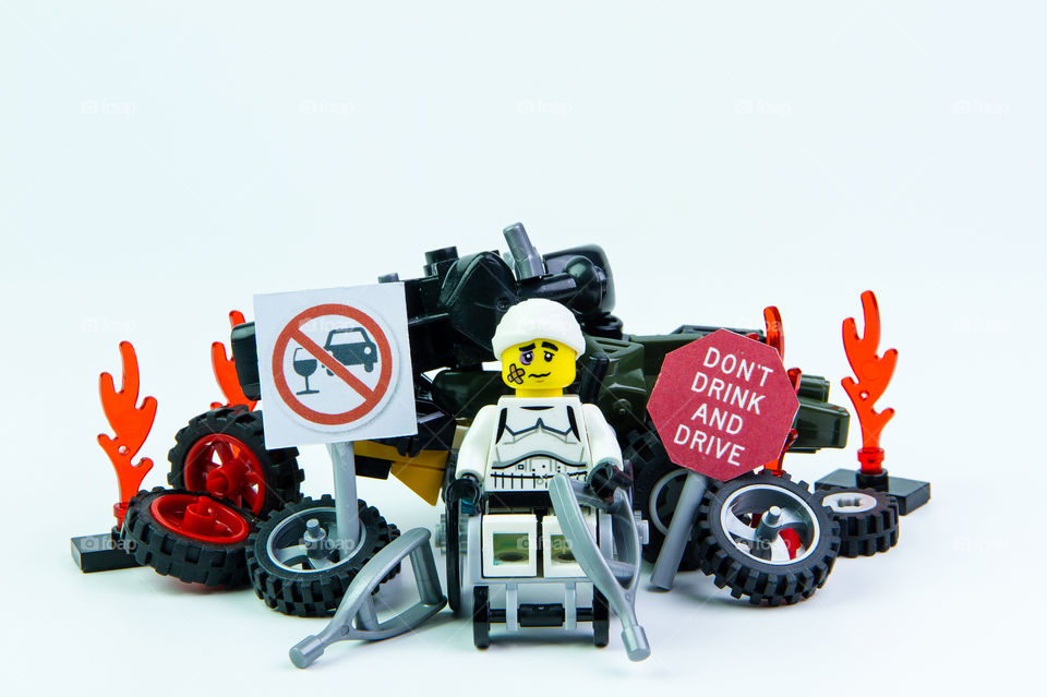 Nonthabure, Thailand - August, 08, 2016 : Lego star wars stormtrooper accident by a drunk driver and a sign Drink don't drive. isolated on white background.Lego is an interlocking brick system collected around the world.