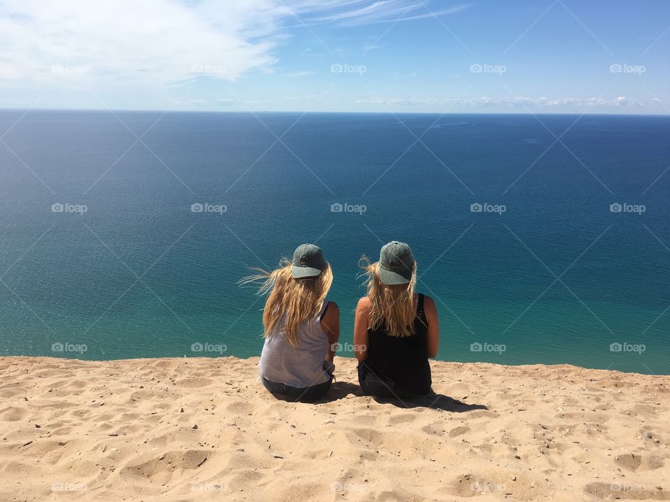 Two girls sitting on beach