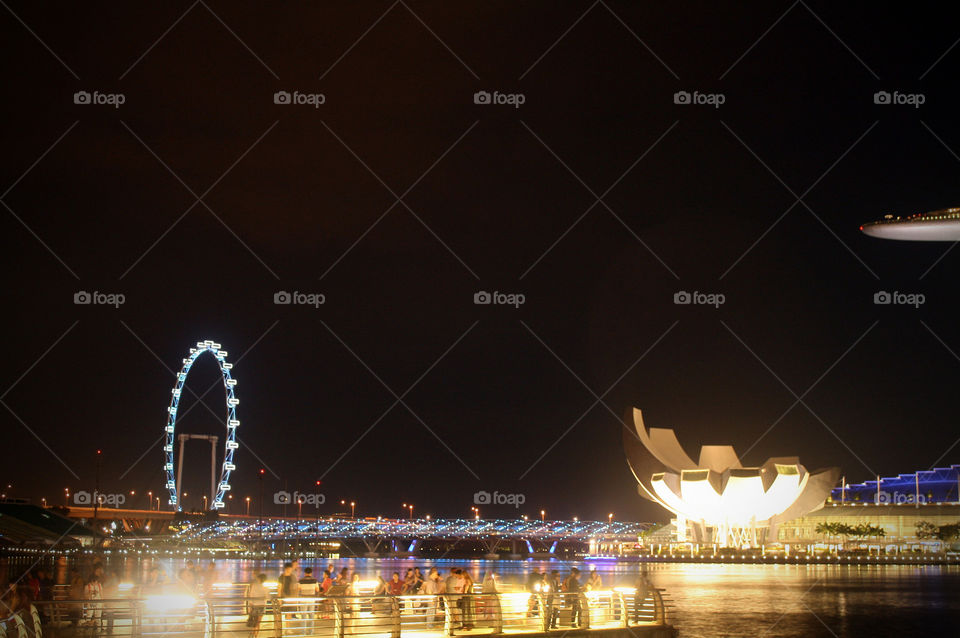 People exploring the Marina Bay view deck at night