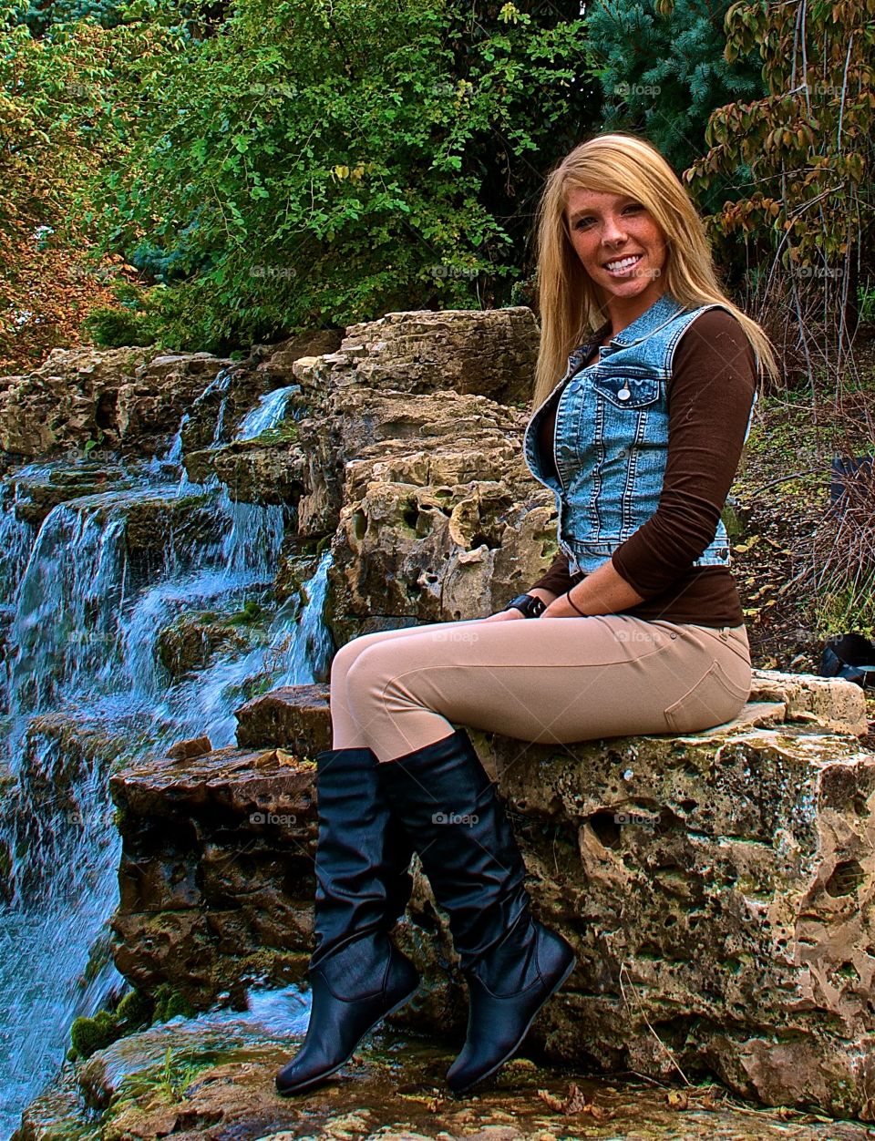 Woman sitting near waterfall