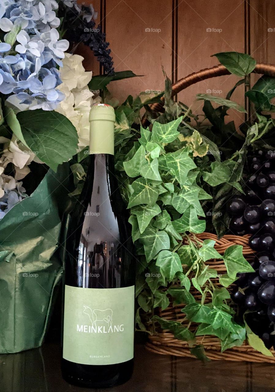 wine bottle, flowers and grapes