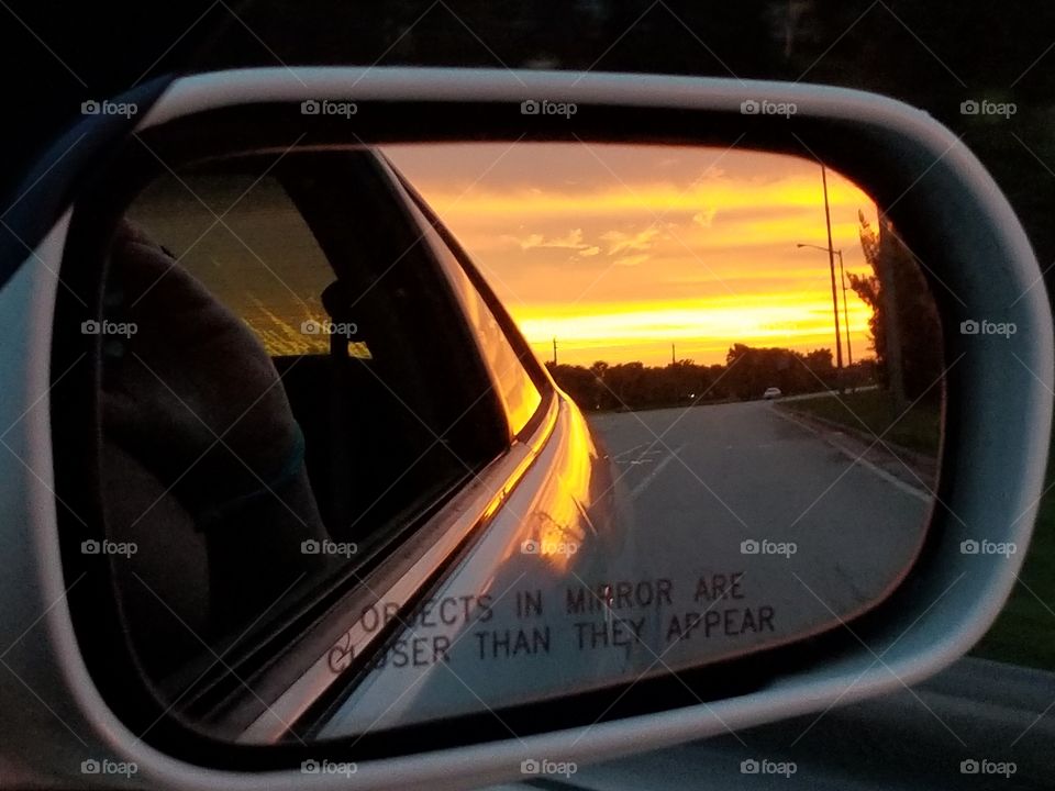 Sunrise in a rearview mirror