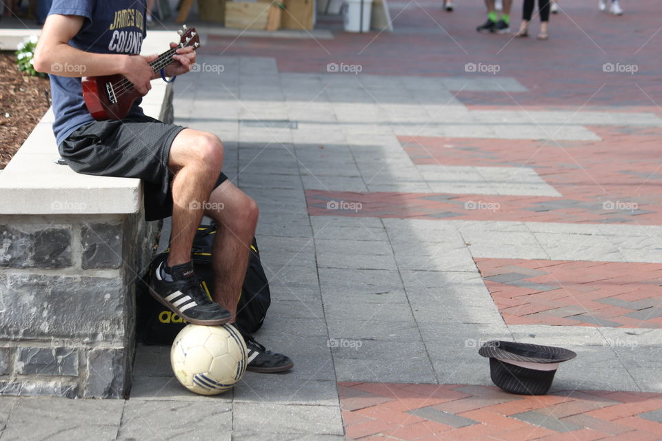 As we were enjoying an outdoor festival this kid was busking, both singing and playing on his ukulele, and doing tricks with the soccer ball. A very talented young man! 