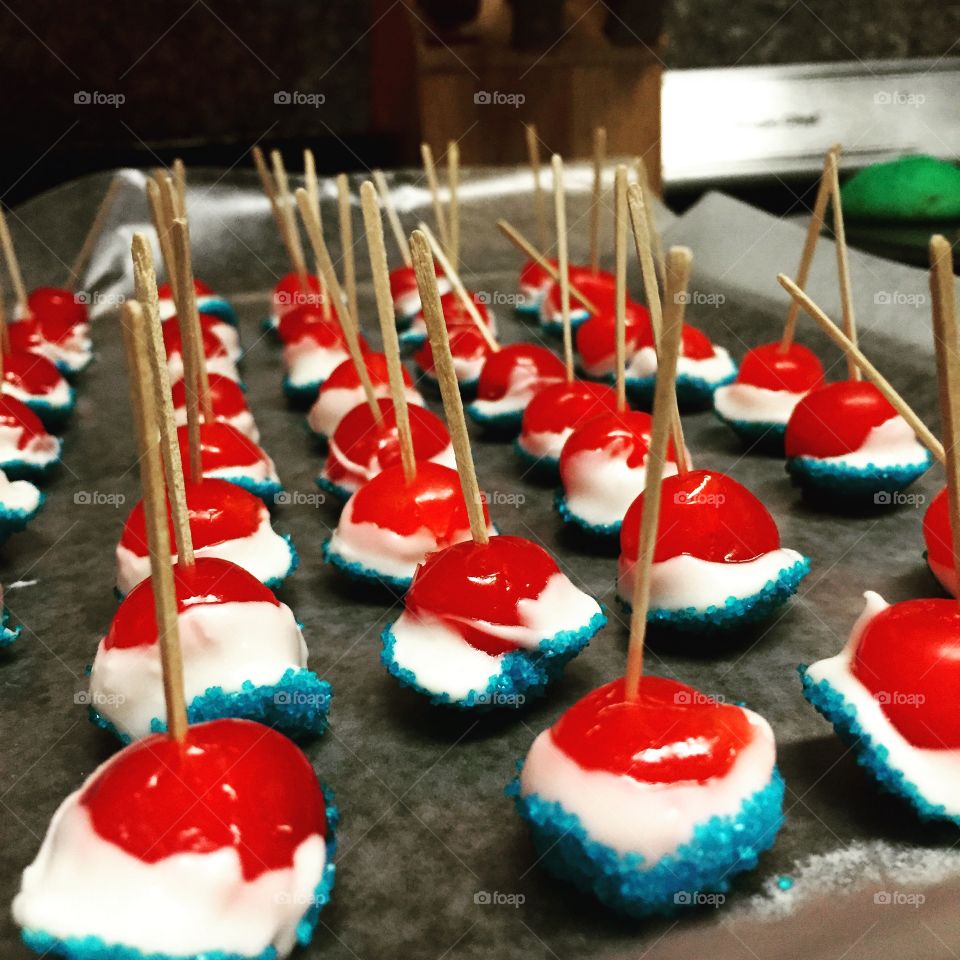 4th of July dessert. A 4th of July dessert. Vanilla vodka soaked cherries dipped in white chocolate and blue sprinkles. 